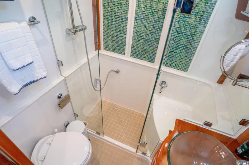 Slide: The Image of Luxurious bathroom in 2016 Sabre 48 Salon Express yacht with glass shower and mosaic tiles. - 34
