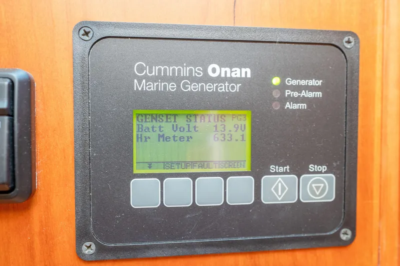Slide: The Image of Cummins Onan marine generator display on 2016 Sabre 48 Salon Express, showing battery voltage and hour meter. - 27