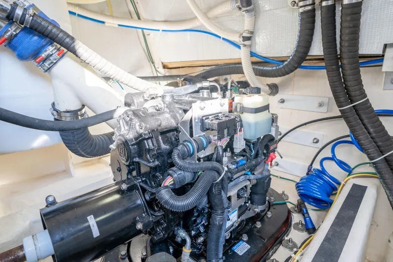 Slide: The Image of Engine room of 2016 Sabre 48 Salon Express with visible mechanical components and wiring. - 52