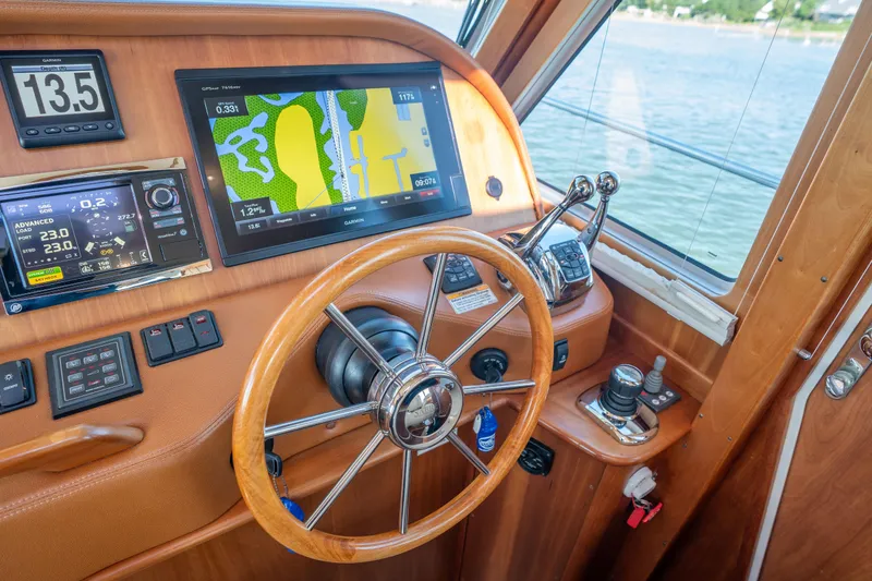 Slide: The Image of Helm of 2016 Sabre 48 Salon Express with navigation screens and controls. - 24