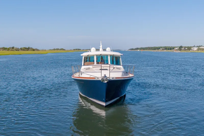 Slide: The Image of 2016 Sabre 48 Salon Express yacht cruising on a serene waterway. - 4
