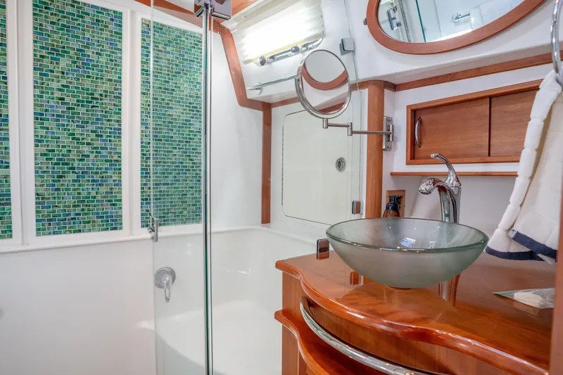 Slide: The Image of Luxurious bathroom in 2016 Sabre 48 Salon Express yacht with glass sink and mosaic tiles. - 33