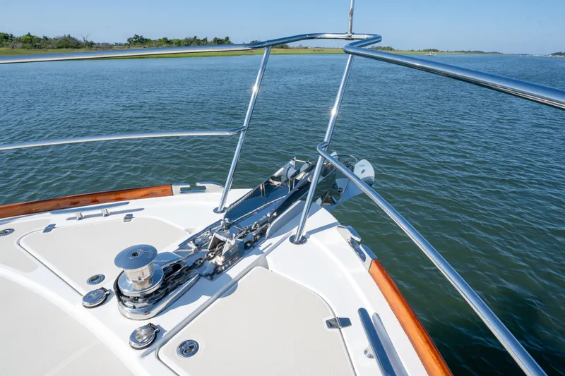 Slide: The Image of Bow of 2016 Sabre 48 Salon Express yacht with stainless steel railings on calm water. - 15