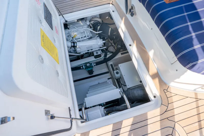 Slide: The Image of Engine compartment of a 2016 Sabre 48 Salon Express yacht, showcasing mechanical components. - 46