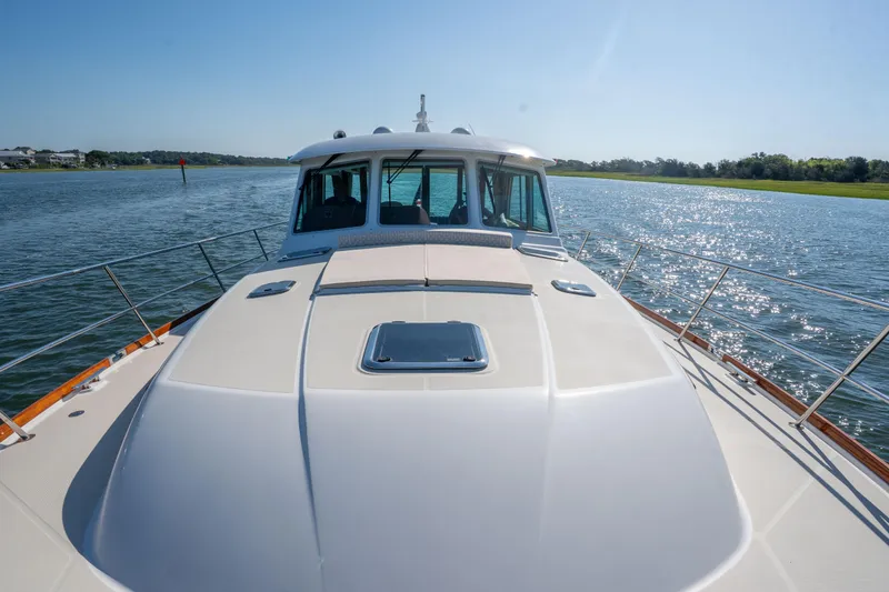 Slide: The Image of 2016 Sabre 48 Salon Express yacht cruising on a sunny day, showcasing sleek design. - 16