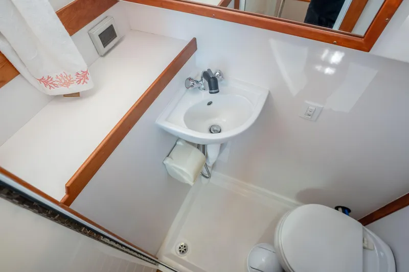 Slide: The Image of Compact bathroom in 2016 Sabre 48 Salon Express yacht, featuring sink and toilet. - 44
