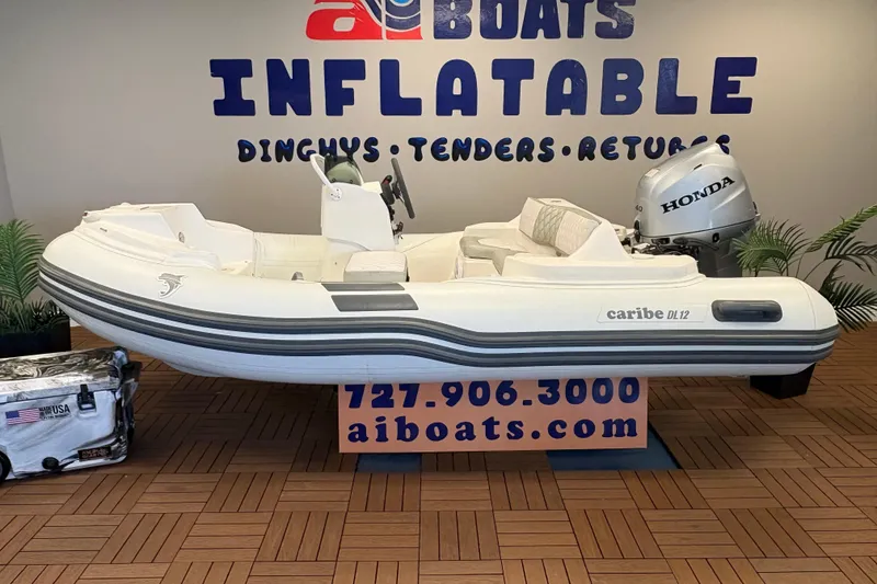 The Image of 2019 Caribe DL12 inflatable boat with Honda motor displayed at AI Boats showroom. - 1