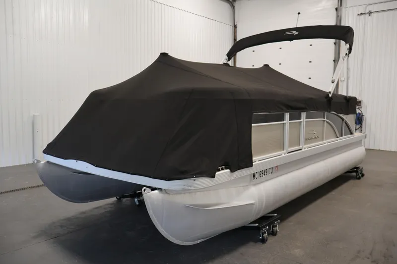 Slide: The Image of 2013 Bennington 20 SLMX pontoon boat with black cover in indoor storage. - 37