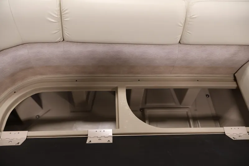 Slide: The Image of 2013 Bennington 20 SLMX boat interior storage compartment with beige upholstery. - 14