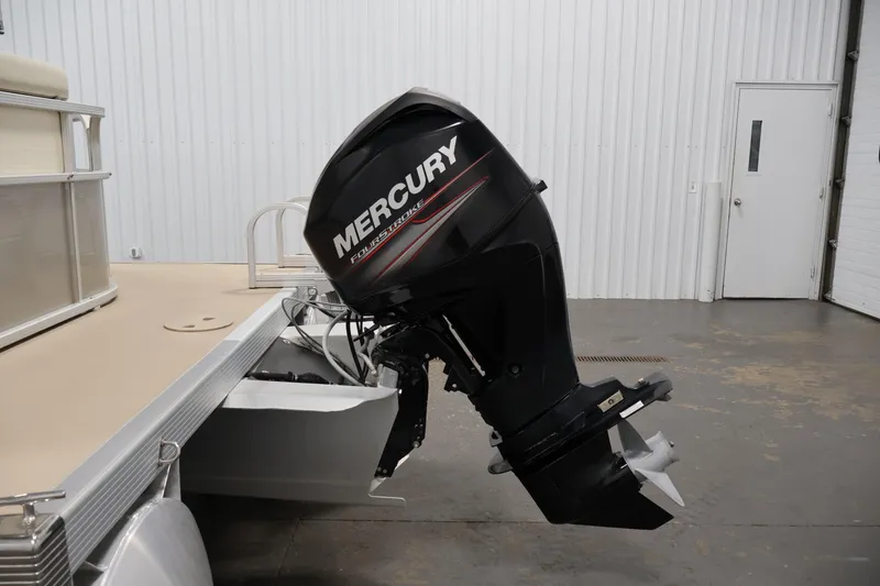 Slide: The Image of 2013 Bennington 20 SLMX pontoon boat with Mercury FourStroke outboard motor in a garage. - 33