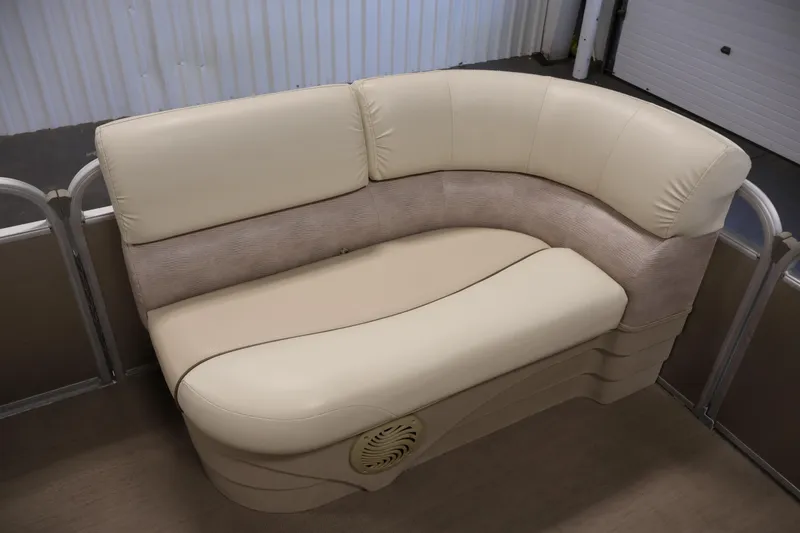 Slide: The Image of 2013 Bennington 20 SLMX boat seating with beige upholstery in a spacious interior. - 11