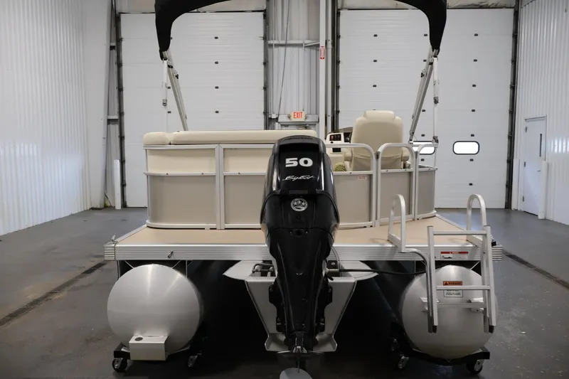 Slide: The Image of 2013 Bennington 20 SLMX pontoon boat with 50 HP engine in indoor storage. - 5