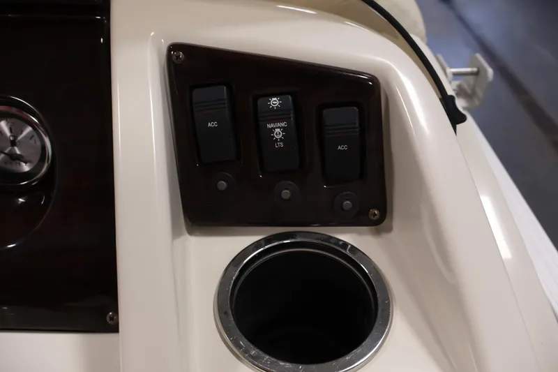 Slide: The Image of Control panel of a 2013 Bennington 20 SLMX boat with switches and cup holder. - 21