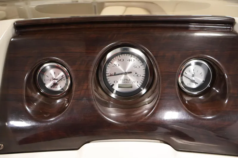Slide: The Image of Dashboard gauges of a 2013 Bennington 20 SLMX boat, featuring RPM and fuel indicators. - 20