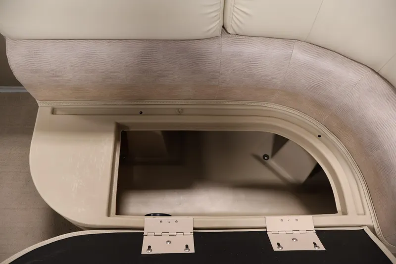 Slide: The Image of 2013 Bennington 20 SLMX boat storage compartment with beige upholstery and open hatch. - 12