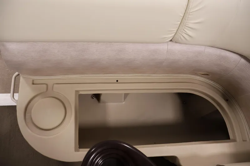 Slide: The Image of Bennington 20 SLMX 2013 boat seat storage compartment with cup holder, beige upholstery. - 29