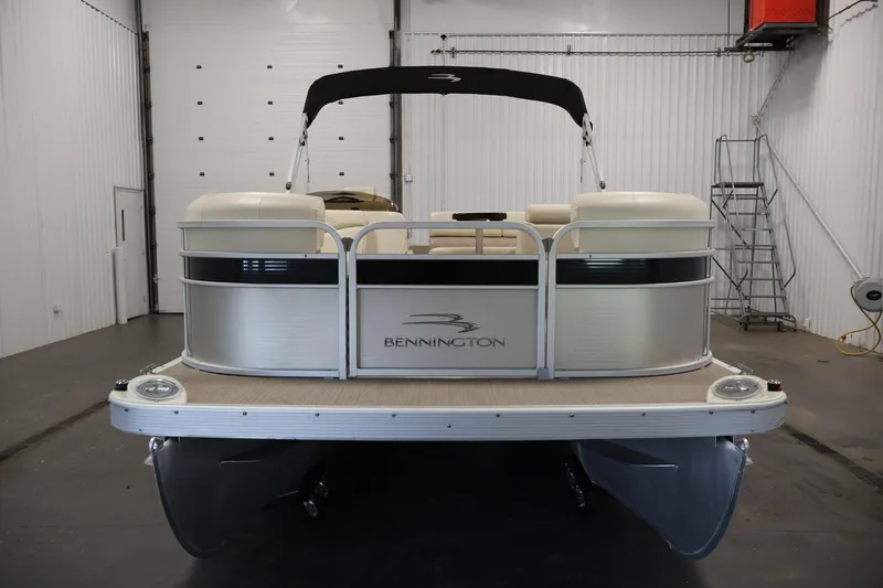 Slide: The Image of 2013 Bennington 20 SLMX pontoon boat in a garage, front view. - 1