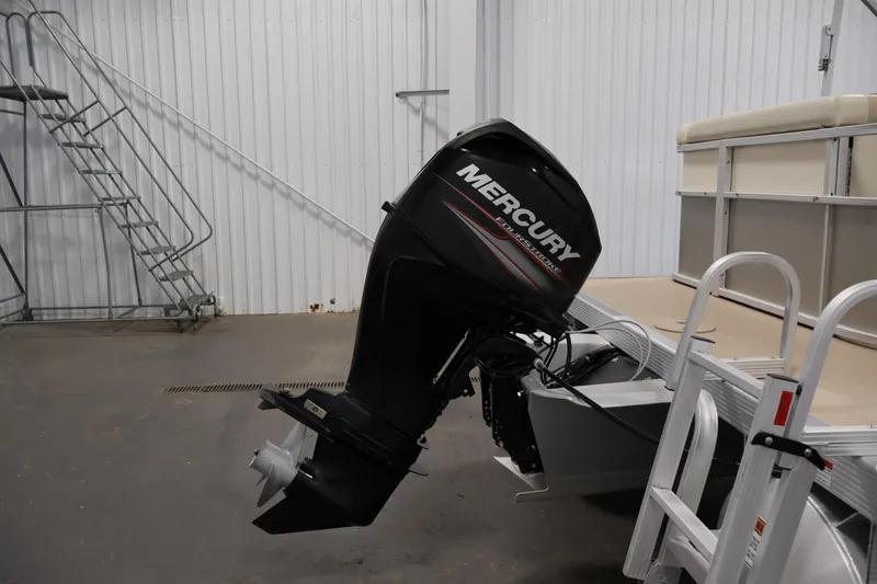 Slide: The Image of 2013 Bennington 20 SLMX boat with Mercury outboard motor in a storage facility. - 34