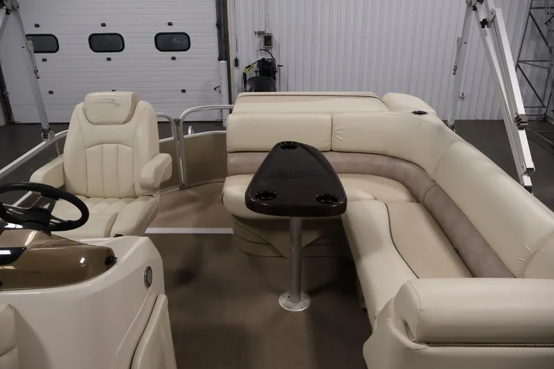 Slide: The Image of Interior of a 2013 Bennington 20 SLMX pontoon boat with beige seating and table. - 27