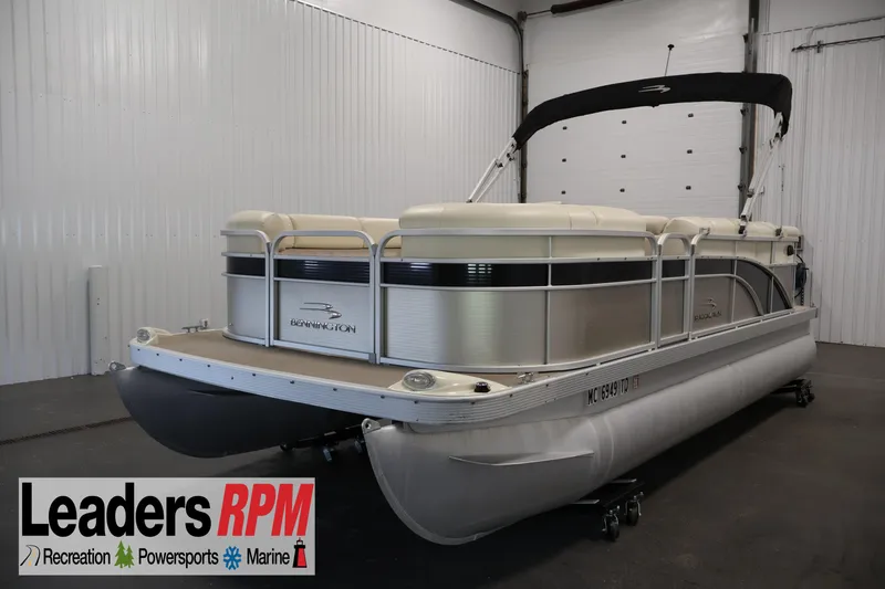 The Image of 2013 Bennington 20 SLMX pontoon boat in indoor showroom, Leaders RPM branding visible. - 0