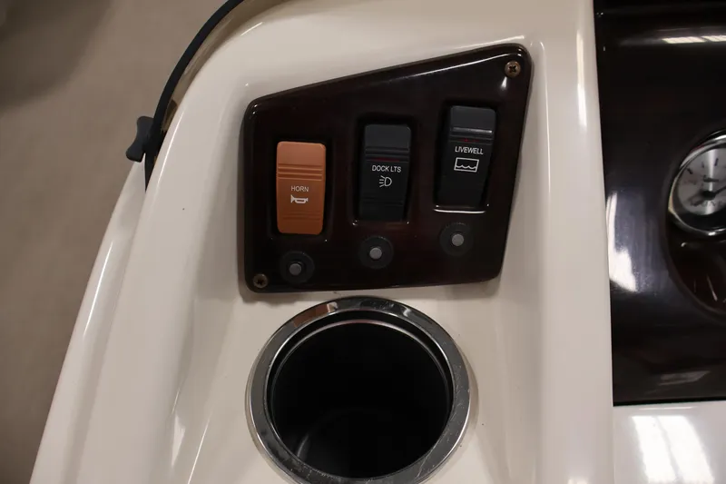 Slide: The Image of Control panel of a 2013 Bennington 20 SLMX boat with switches and cup holder. - 19
