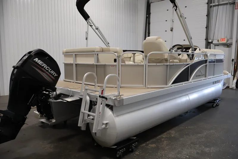 Slide: The Image of 2013 Bennington 20 SLMX pontoon boat with Mercury outboard motor in a garage setting. - 4