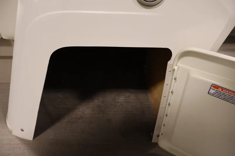 Slide: The Image of Open storage compartment on a 2013 Bennington 20 SLMX boat. - 16