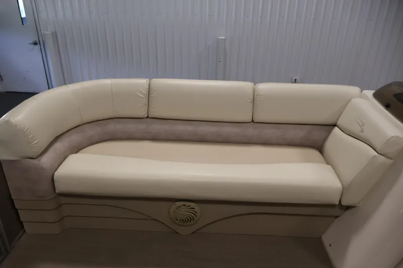 Slide: The Image of 2013 Bennington 20 SLMX boat interior with beige cushioned seating. - 13
