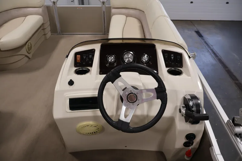 Slide: The Image of Steering console of a 2013 Bennington 20 SLMX pontoon boat with beige interior. - 17