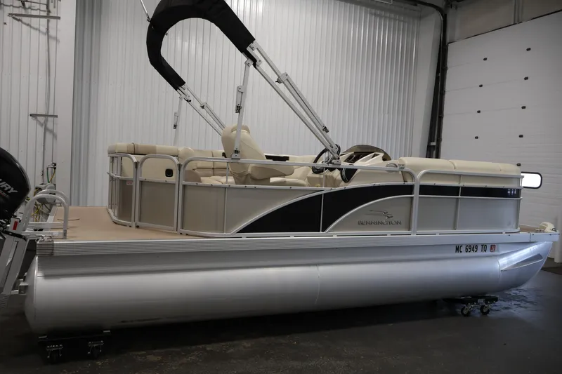 Slide: The Image of 2013 Bennington 20 SLMX pontoon boat in indoor storage, side view. - 3