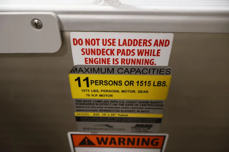 Slide: The Image of Safety warning label on 2013 Bennington 20 SLMX boat, indicating maximum capacity and usage instructions. - 25