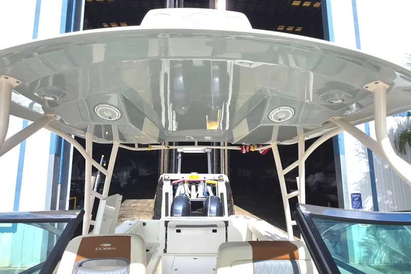 Slide: The Image of 2019 Cobia 280 Dual Console boat interior with T-top and seating. - 5