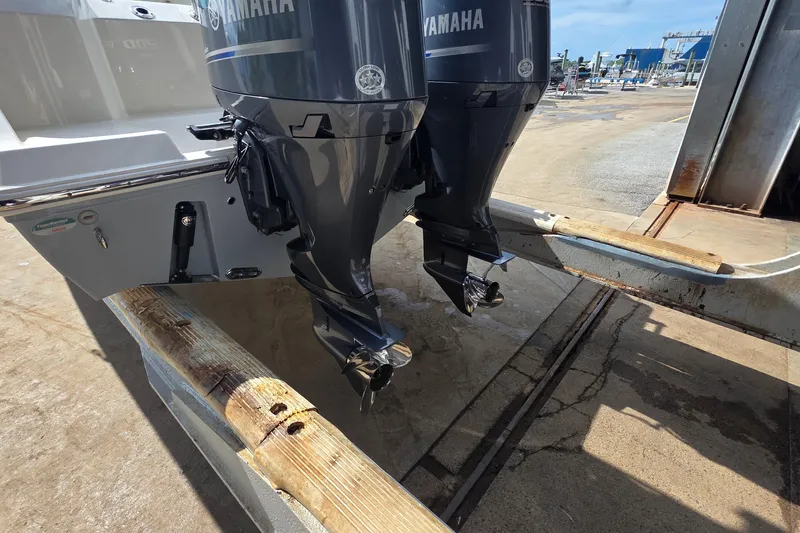Slide: The Image of 2019 Cobia 280 Dual Console with twin Yamaha outboard motors on a trailer. - 14