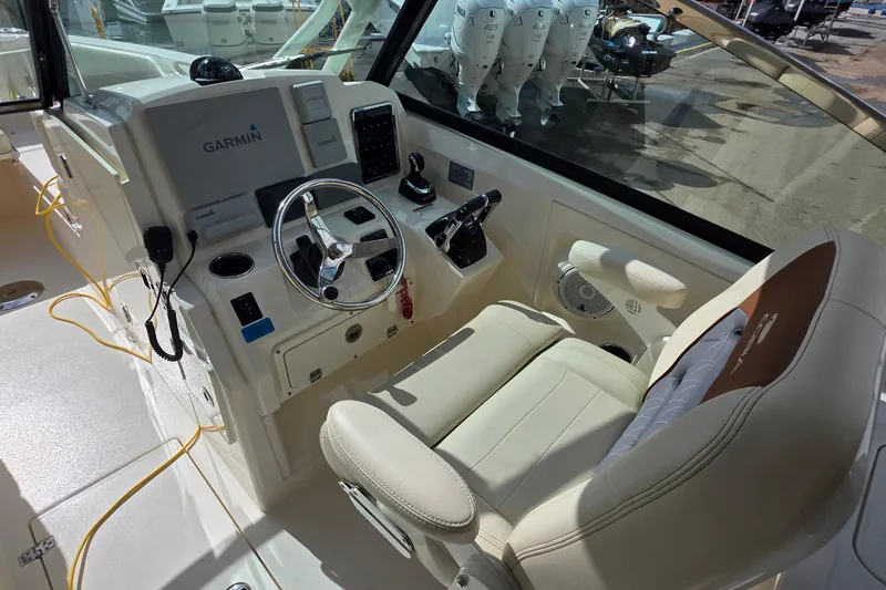 Slide: The Image of 2019 Cobia 280 Dual Console boat cockpit with Garmin navigation system. - 17