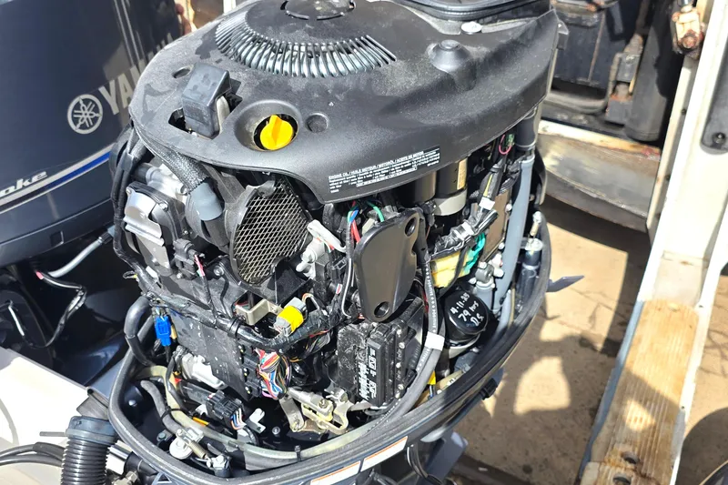 Slide: The Image of Open Yamaha outboard engine on a 2019 Cobia 280 Dual Console boat. - 6