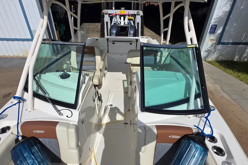 Slide: The Image of 2019 Cobia 280 Dual Console boat interior with open windshield and seating. - 12