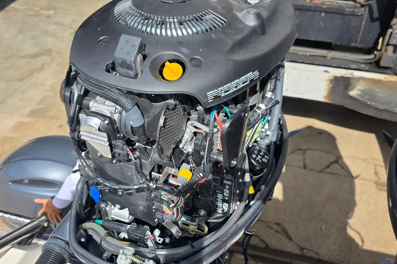 Slide: The Image of Open outboard motor of a 2019 Cobia 280 Dual Console boat, showing internal components. - 7