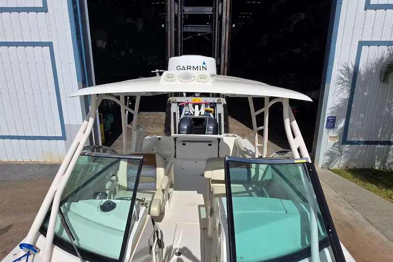 Slide: The Image of 2019 Cobia 280 Dual Console boat with Garmin equipment in a storage facility. - 15