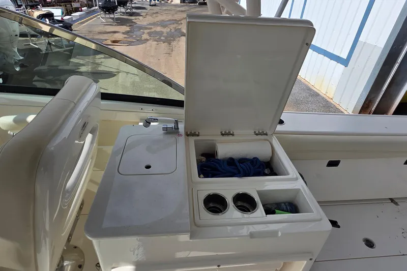 Slide: The Image of 2019 Cobia 280 Dual Console boat interior with storage compartment open. - 18