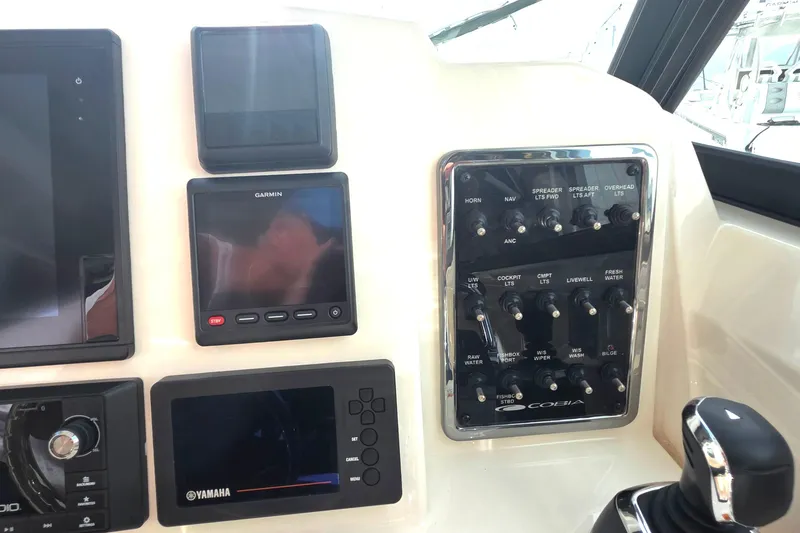Slide: The Image of Control panel of a 2019 Cobia 280 Dual Console boat with Garmin and Yamaha displays. - 23