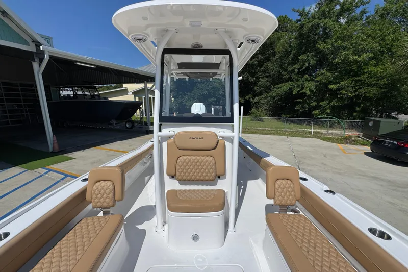 Slide: The Image of 2027 Caymas 26 HB boat interior with tan seating and center console. - 25