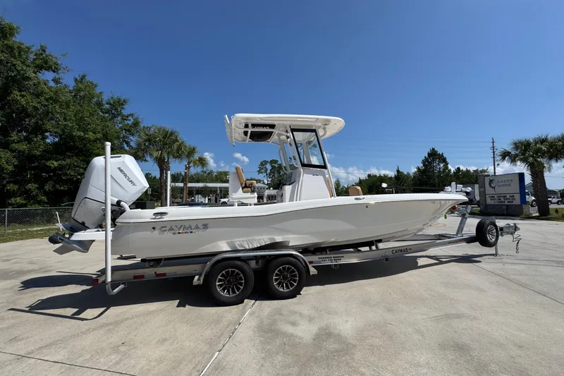 Slide: The Image of 2027 Caymas 26 HB boat on trailer, parked outdoors under clear blue sky. - 11