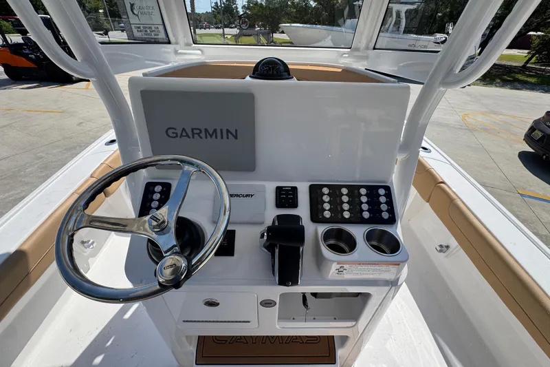 Slide: The Image of 2027 Caymas 26 HB boat console with Garmin display and steering wheel. - 34