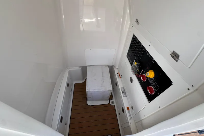 Slide: The Image of Interior of 2027 Caymas 26 HB boat featuring control panel and storage area. - 28
