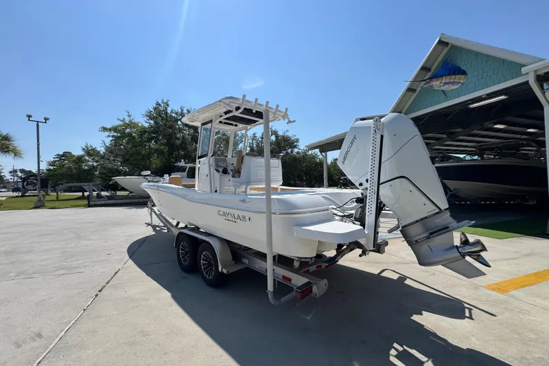 Slide: The Image of 2027 Caymas 26 HB boat on trailer, parked outdoors under clear sky. - 17