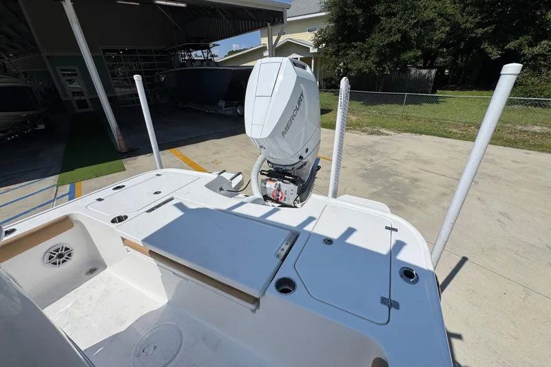 Slide: The Image of 2027 Caymas 26 HB boat with Mercury outboard engine in a sunny outdoor setting. - 39