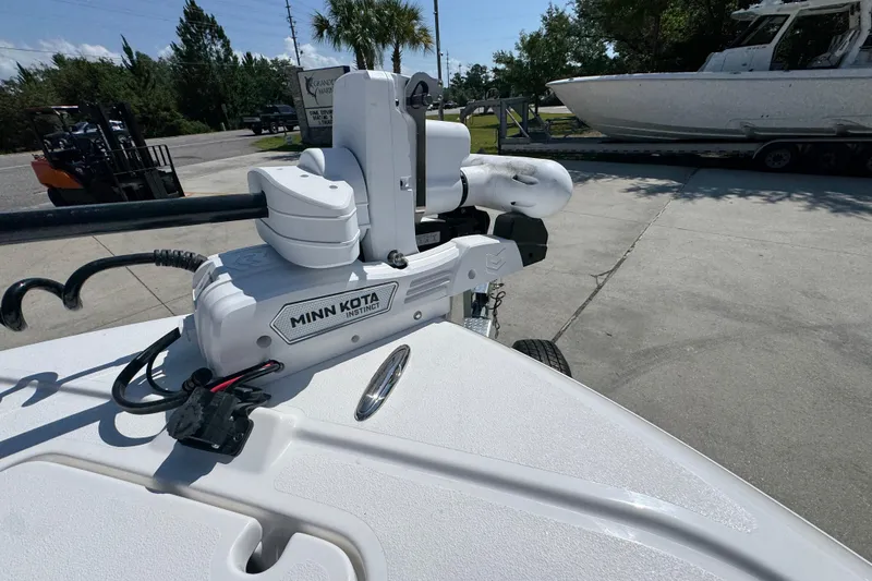 Slide: The Image of Minn Kota Instinct motor on 2027 Caymas 26 HB boat, parked outdoors. - 22