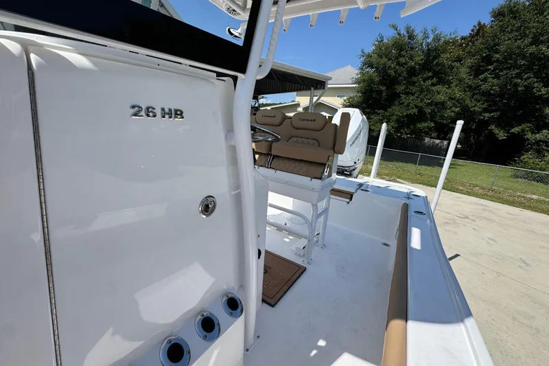 Slide: The Image of 2027 Caymas 26 HB boat interior with seating and console, showcasing modern design. - 26