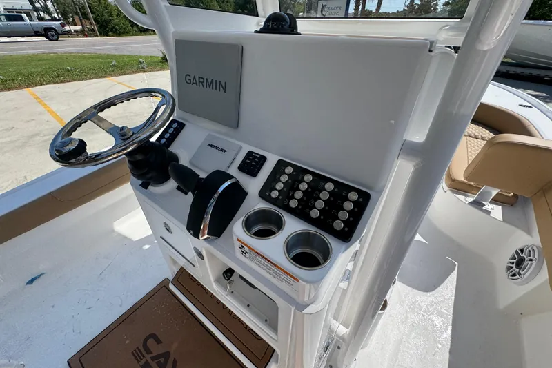 Slide: The Image of Helm of 2027 Caymas 26 HB boat with Garmin navigation system and Mercury controls. - 36