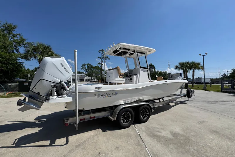 Slide: The Image of 2027 Caymas 26 HB boat on trailer, featuring a powerful Mercury outboard motor. - 12